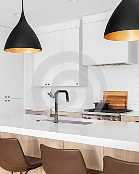 A kitchen detail with white and white oak cabinets.
