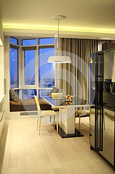 The kitchen and dining area with bay window in a