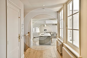 a kitchen and dining room with large windows and wood