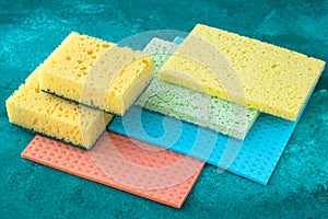 Kitchen dishcloth, cleanup concept, housework. Colorful kitchen sponges for cleaning close-up, housekeeping