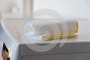 Kitchen Dishcloth sitting on top of a white Kitchen Appliance