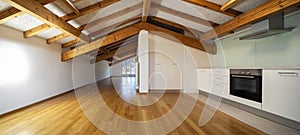 Kitchen in empty apartment with wooden beams