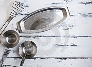Kitchen empty metal objects on a white wooden background