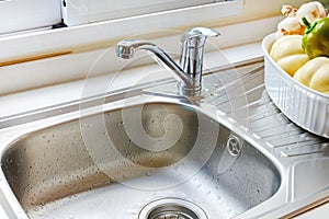 Kitchen faucet with a flowing water