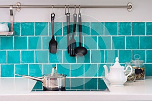 Kitchen features dark gray flat front cabinets paired with white quartz countertops