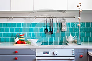 Kitchen features dark gray flat front cabinets paired with white quartz countertops and a glossy blue care tile.