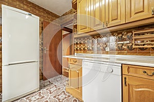 kitchen furnished with Castilian-style wooden furniture and striking vintage tiles on floors and walls