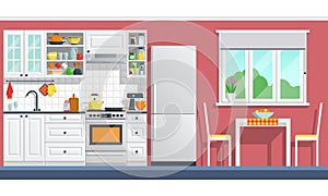 Kitchen furniture with appliances on a red wall.