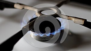 Kitchen gas stove with burning blue natural gas