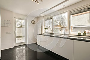 the kitchen has a large window and a large sink