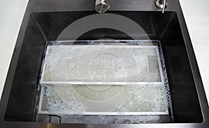 kitchen hood filters for sinks with a modern oxygen cleaner for grease and stains. Washing and cleaning the kitchen