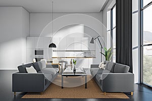 Kitchen interior with couch and eating table, chill area and panoramic window