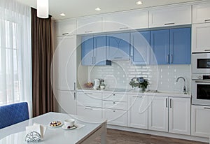 Kitchen interior design with white and blue kitchen furniture