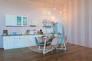 Kitchen interior with large dining table in modern apartment