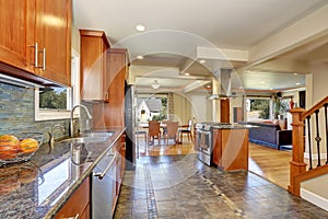 Kitchen interior with tile flooring and brown cabinets
