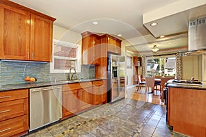 Kitchen interior with tile flooring and brown cabinets