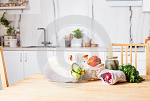 Kitchen interiour and table with groceries in textile bags