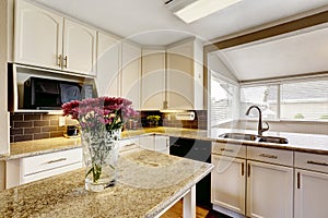 Kitchen island with granite top and flowers