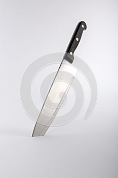 Kitchen knife embedded in surface photo