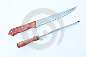 Kitchen knife with sharpening steel on white background