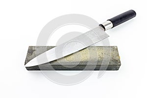 Kitchen knife and whetstone on isolated white background with clipping path