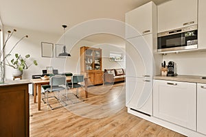 a kitchen and living room with a dining room table