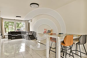 a kitchen and living room with a table and chairs