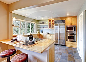 Kitchen with maple cabinets and steel appliances