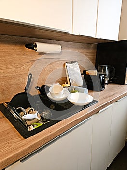 Kitchen Mess, Overfull Sink, Waiting To Be Cleaned, a lot of dirty dishes photo