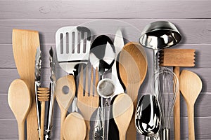 Kitchen metal and wooden utensil on background