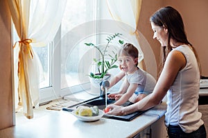 Kitchen mom son wash fruits and vegetables