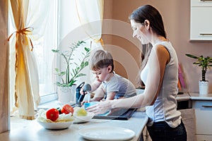 Kitchen mom son wash fruits and vegetables