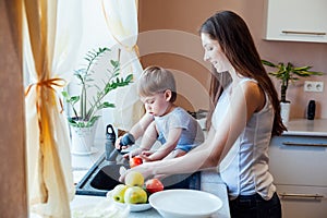 Kitchen mom son wash fruits and vegetables