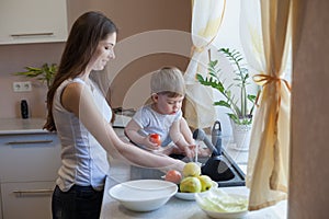 Kitchen mom son wash fruits and vegetables