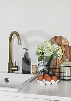 Kitchen morning view - cutting wooden boards, a bouquet of hydrangeas in a basket, eggs in a ceramic stand on the kitchen table