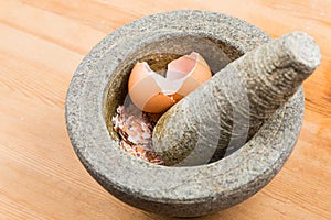 Kitchen mortar and pestle with crashed egg shell