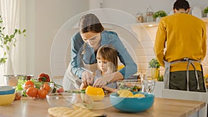 In Kitchen: Mother and Cute Little Daughter Cooking Together Healthy Dinner. Mom Teaches Little Gi