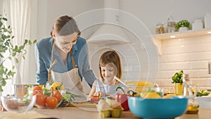 In Kitchen: Mother, Cute Little Daughter Cooking Together Healthy Dinner. Mother Teaches Little Gi