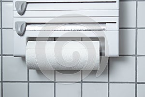 A kitchen paper towel roll hanging on the wall in the kitchen