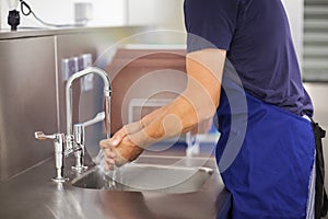 Kitchen porter washing his hands