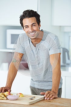 Kitchen portrait, fruits and happy man cooking healthy food, home recipe or clean eating snack, morning breakfast or