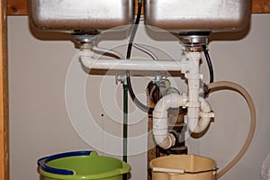 Kitchen Remodel Closeup of Under Sink Plumbing with Buckets