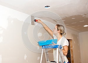 Kitchen Remodel Young Woman Taping Ceiling Joint