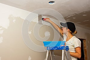 Kitchen Remodel Young Woman Taping Ceiling Joint Wearing Hat