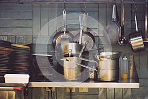 Kitchen of the restaurant. Iron cookware in a restaurant: pots, stewpan, pans, plates, ladles