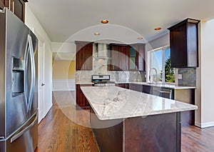 Kitchen room interior with deep brown cabinets with granite counter top