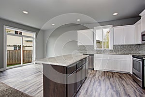 Kitchen room interior of an empty house. Glass doors overlooking the back yard.