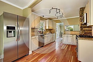 Kitchen room with white cabinets, stainless steel and hardwood floor