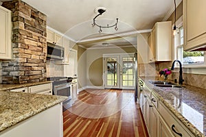 Kitchen room with white cabinets, stainless steel and hardwood floor