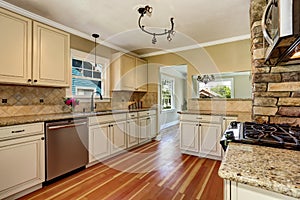 Kitchen room with white cabinets, stainless steel and hardwood floor